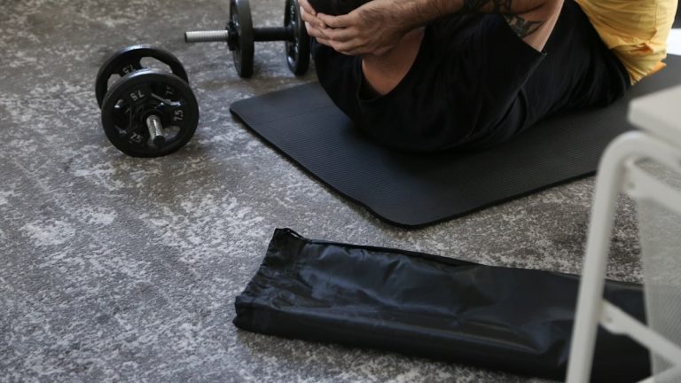 a man is doing exercises on a mat with a barbell